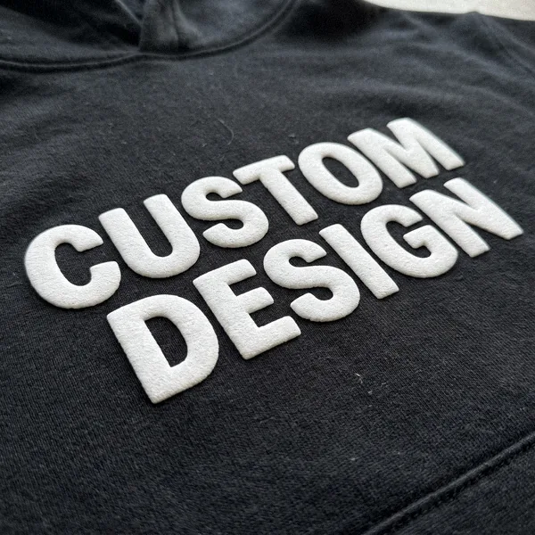 Raised puff print CUSTOM DESIGN lettering on a hoodie close-up