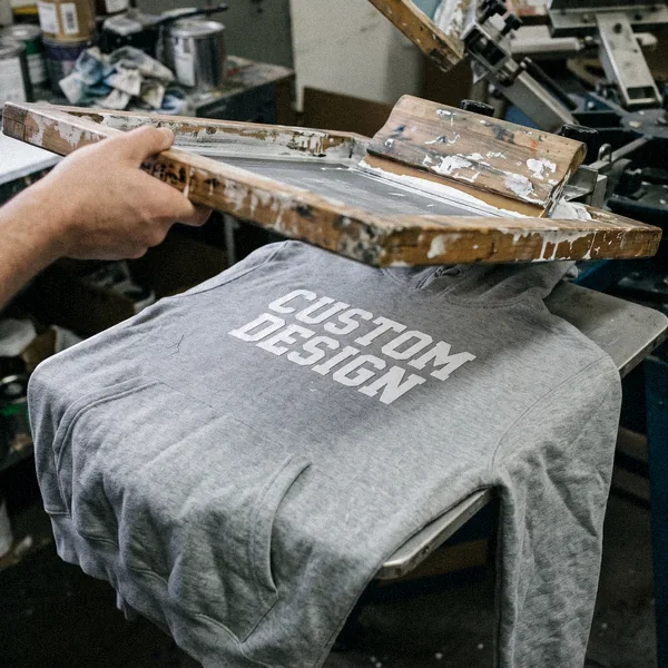 Screen printed CUSTOM DESIGN graphic on a hoodie under a print screen