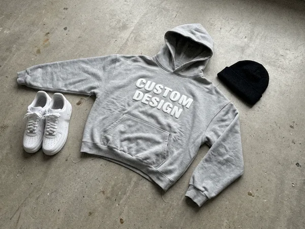 Oversized streetwear hoodie with CUSTOM DESIGN puff print on a concrete floor