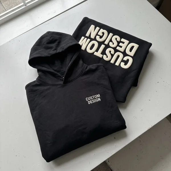 Hoodie with embroidered chest text and a puff-printed back design