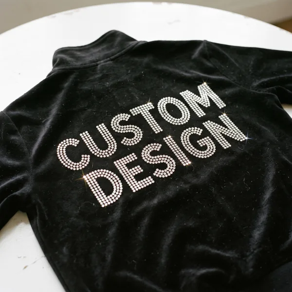Rhinestone custom design lettering on the back of a black velour tracksuit jacket