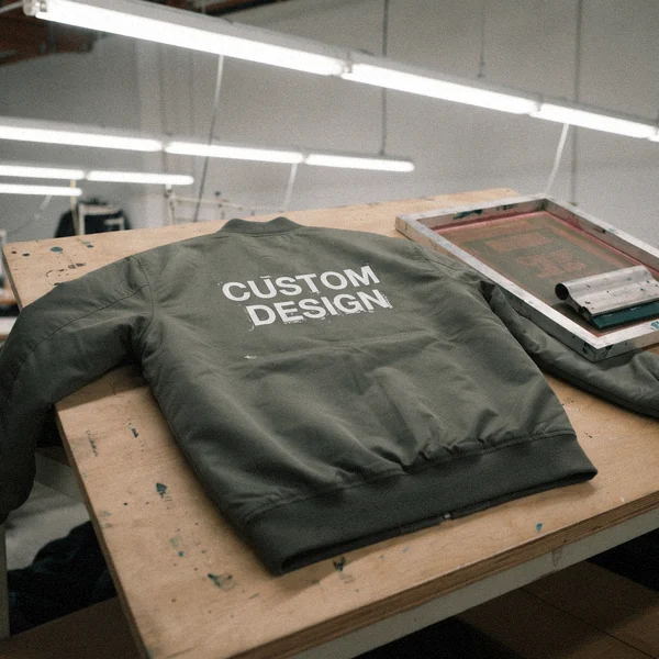 Screen printed CUSTOM DESIGN graphic on the back of a twill bomber jacket