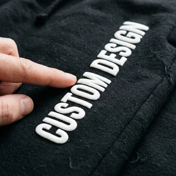 Raised puff print reading CUSTOM DESIGN on a heavyweight sweatsuit jogger leg